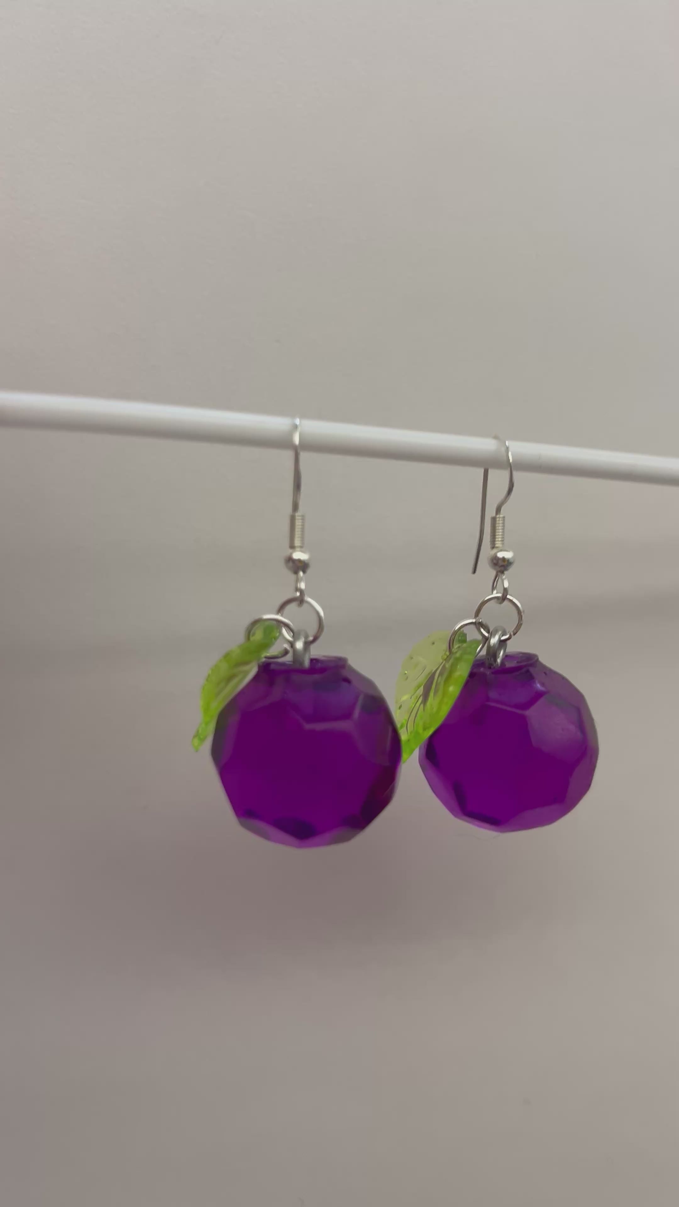 Video of grape inspired purple earrings with leaf attached